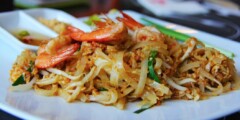 Pad Thai with shrimp on a white plate.