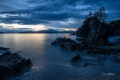 Cloudy Bamfield coast sunrise with islands on horizon