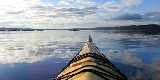 A view from a kayak on crystal blue water.